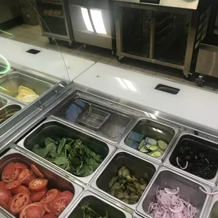 a variety of salads in containers