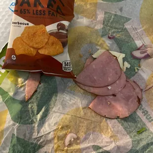 a bag of chips and a ham sandwich