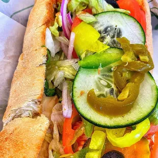a sub sandwich with vegetables and olives