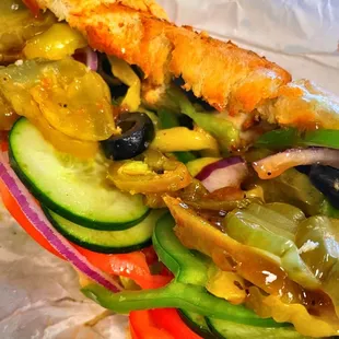 a closeup of a sandwich with vegetables