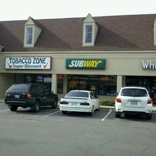 three cars parked in a parking lot