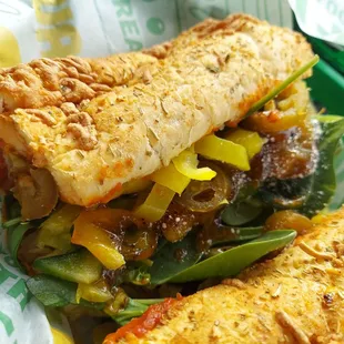 a sub sandwich with vegetables and cheese