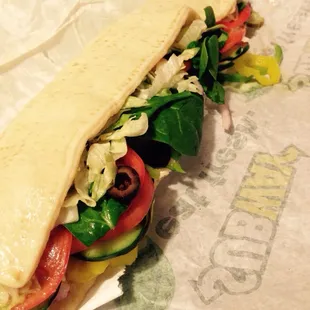 Picked up Subway after shopping at Costco. I got this tasty flat bread tuna sandwich. Bright and colorful!