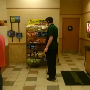 Guy behind the counter, working his ass off. Guy right here, listening to his skullcandy headphones and ignoring his partner.