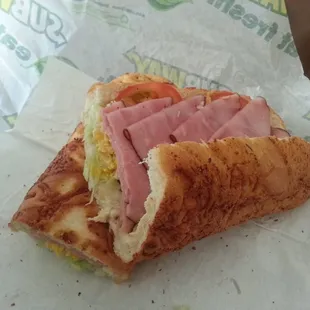 a ham and cheese sandwich on a wrapper