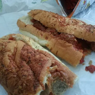 a meatball sub sandwich with a side of ketchup