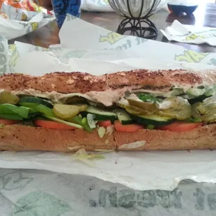 a sub sandwich with vegetables and meat