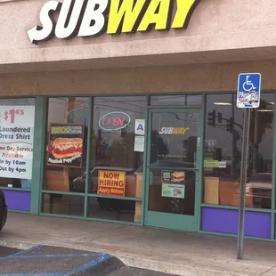 a car parked in front of a subway restaurant