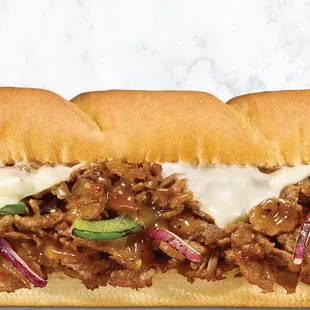 a beef sandwich with cheese and pickles