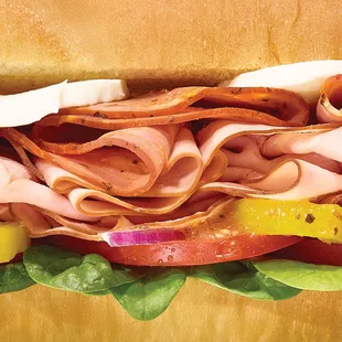 a sub sandwich with meat and vegetables