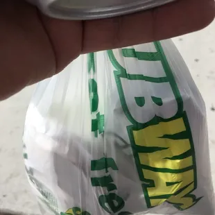 a person holding a can of soda