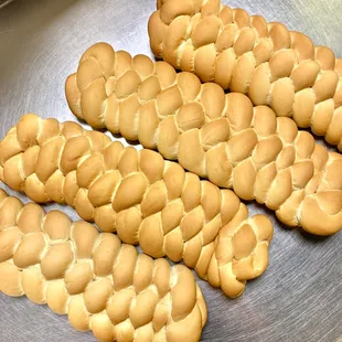 a bunch of braided bread on a tray