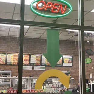 an open sign in the window of a restaurant