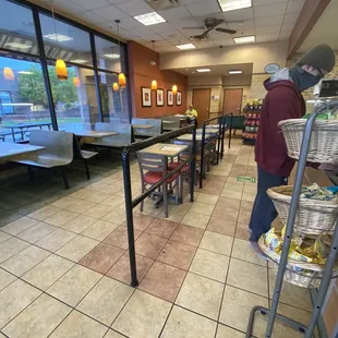 a man standing in a restaurant waiting for customers