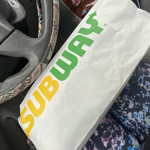 a paper bag in the passenger seat of a car