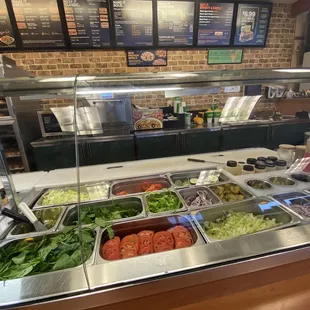 a salad bar with a variety of salads