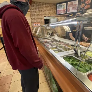 a man wearing a face mask in a restaurant