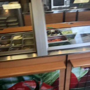 a view of a food counter with a variety of food items