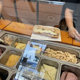 a man behind a counter with a tray of food