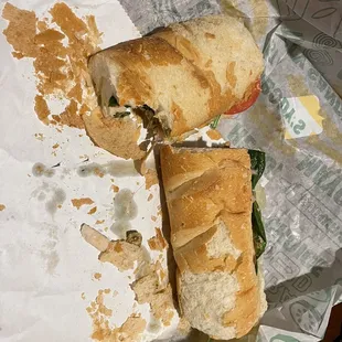 a half eaten sandwich on a wrapper
