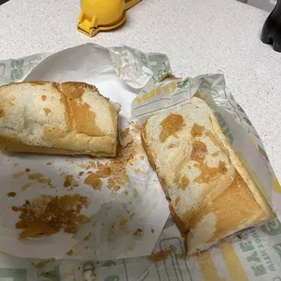 a half eaten sandwich and a half eaten sandwich