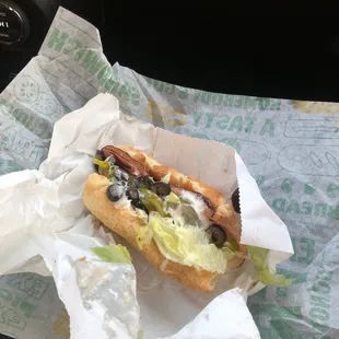 a hot dog in a wrapper on a table