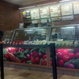 a man standing in front of a food counter