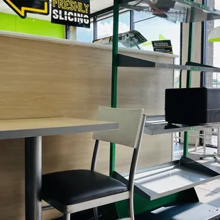 a view of a train station with a bench and a table