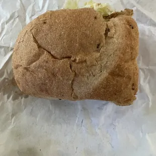 a half eaten sandwich on a piece of paper