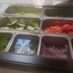 a variety of vegetables in trays