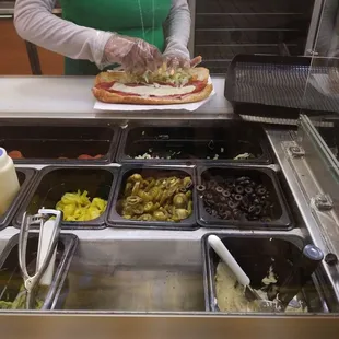 a woman preparing food in a subway