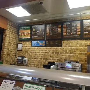 menus on a brick wall in a restaurant