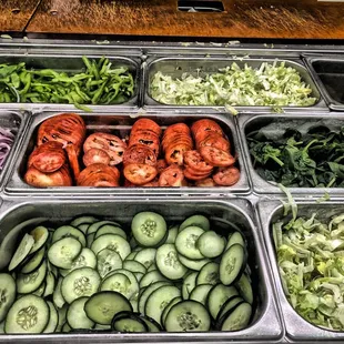 a variety of vegetables in trays