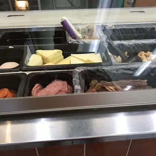 an assortment of food in a display case
