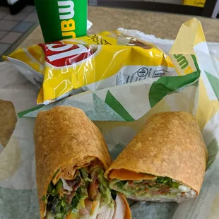 a wrap and chips on a table