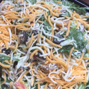 a salad with cheese and lettuce