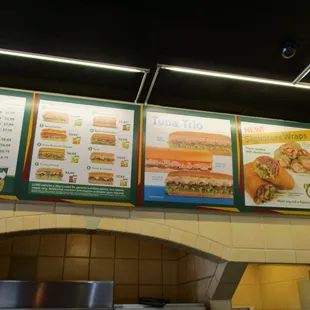 subway menus on a brick wall