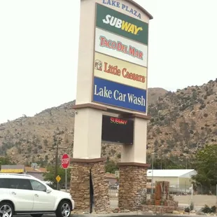 a car parked in front of a sign