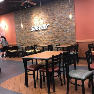 a dining area with tables and chairs