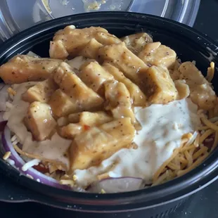 Sweet Onion Chicken Teriyaki Salad with onion&apos;s, tomatoes and cheese topped with ranch dressing