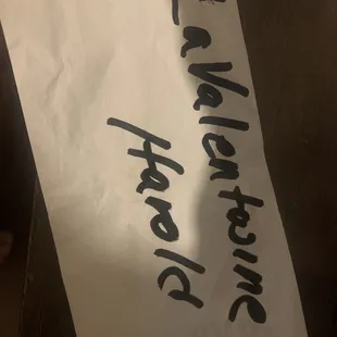 a piece of paper with a sign on it