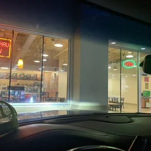 Drive thru and open signed both lit up and 3 workers inside