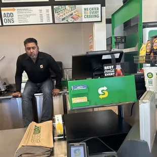 Store employee just sitting on counter where they prepare food!