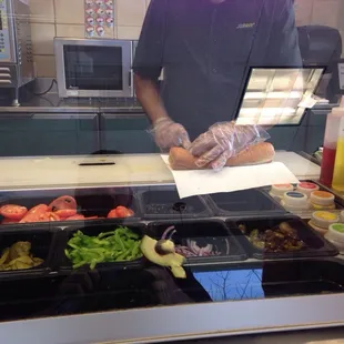 a man preparing food in a subway