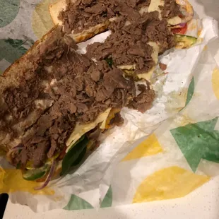 a sub sandwich with meat and vegetables
