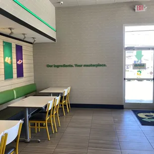 empty tables and chairs in a subway restaurant
