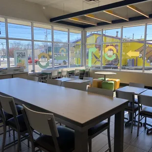 a view of a dining area with tables and chairs
