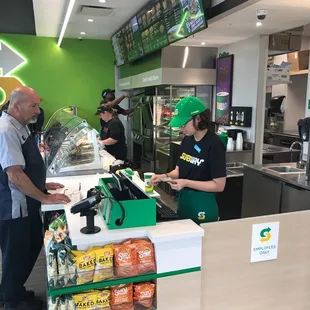 a man and a woman ordering food at a subway subway