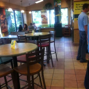 a man standing at a table in a restaurant