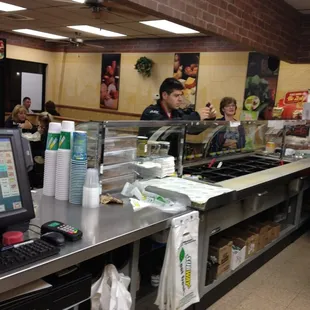a man and a woman behind a counter